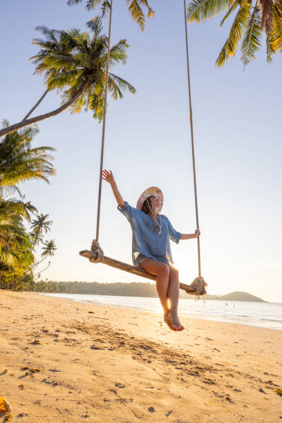 istock Woman Relaxing on a Beach Swing at Sunset 2192871146