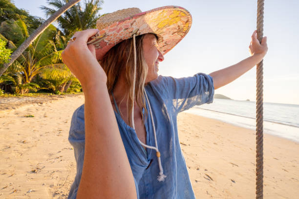 istock Woman Relaxing on Swing at Tropical Beach 2192871212