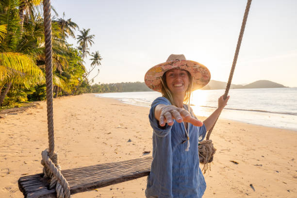 istock Woman on Beach Swing Reaching for Partner 2192871296