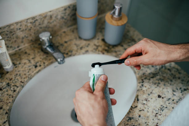 istock Detail of a man putting toothpaste on his toothbrush 2192871765