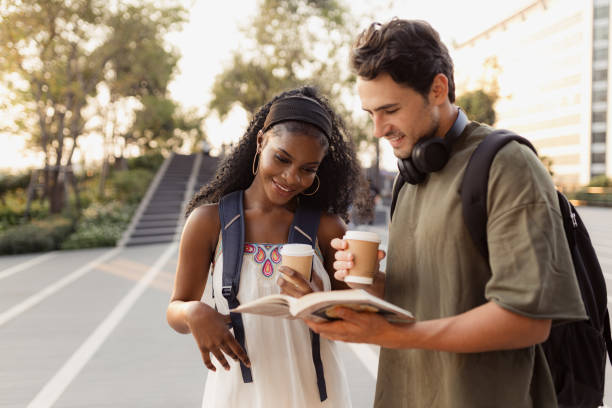 istock Two Friends Sharing Coffee Outdoors While Studying Together on a Sunny Day 2192873696
