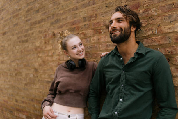 istock Smiling Friends Enjoying a Relaxed Moment Against a Brick Wall 2192875365