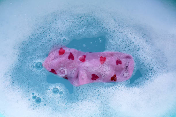 istock Dirty socks soaked in water, dissolving detergent in blue basin. 2192876229