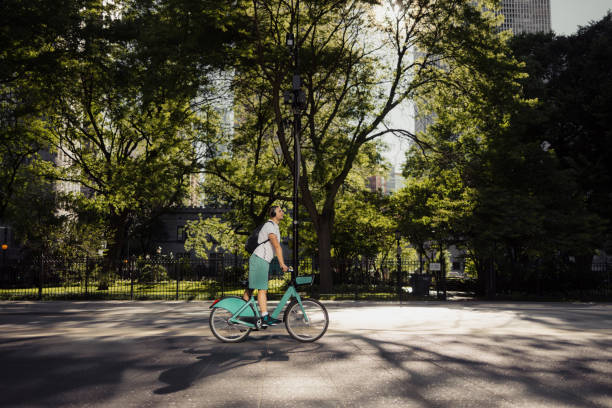 istock Cyclist Enjoying a Ride Through a Sunlit Urban Park Setting 2192876454