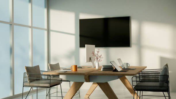 istock A modern, simple office room featuring a wooden table with office supplies on top. 2192890301