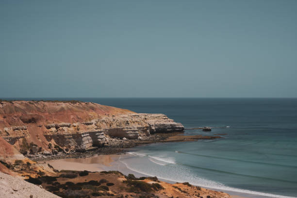 istock Port Willunga rocky cliff face and secluded beach with calming waves 2192891760