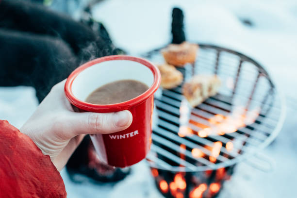 istock Cozy Winter Coffee Outdoors and Cinnamon Buns Over Open Fire 2192893574