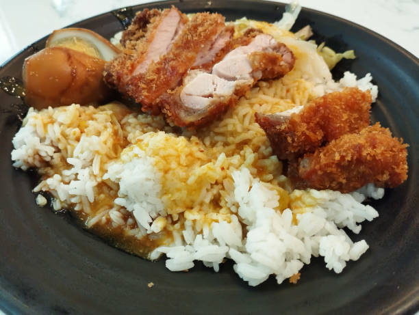 istock pork cutlet curry rice in a black plate 2192902168