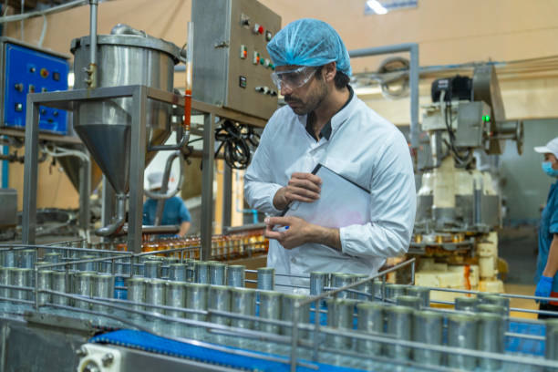 istock A quality control inspector monitors production at an automated food processing plant, using a clipboard for documentation. The scene highlights precision and efficiency in industrial manufacturing. 2192902277