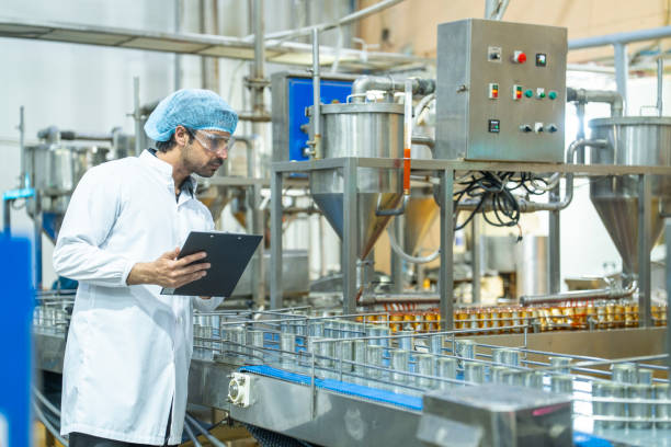 istock A quality control inspector monitors production at an automated food processing plant, using a clipboard for documentation. The scene highlights precision and efficiency in industrial manufacturing. 2192902592
