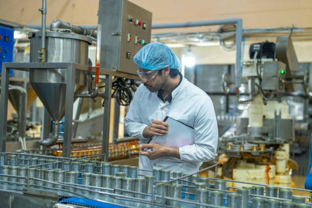 istock A quality control inspector monitors production at an automated food processing plant, using a clipboard for documentation. The scene highlights precision and efficiency in industrial manufacturing. 2192903769
