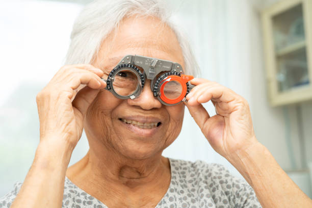 istock Asian senior woman wearing ophthalmic vision eye test and using optical trial frame. 2192906889