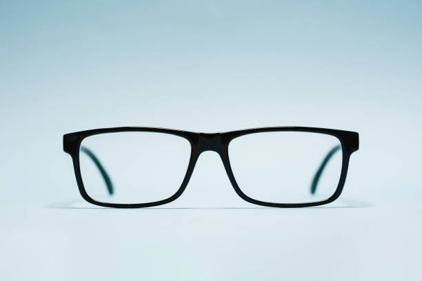 Front view of prescription glasses with plastic black frames on blue background