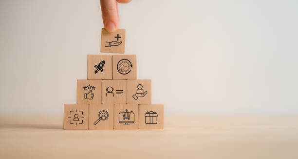 istock Value added concept. Way to adding value to product and service. Wooden blocks with value added icons. Improving products, excellent service, expert advice, consistently upgrade, deliver fast. 2192909303