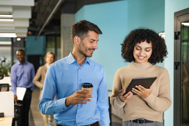 istock Two business people discussing work together using a tablet in a modern office 2192909671