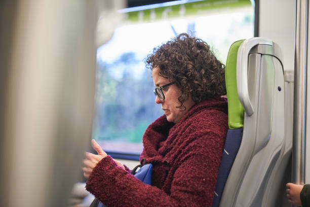 istock Woman seated on a train engrossed in her phone during a journey 2192917546