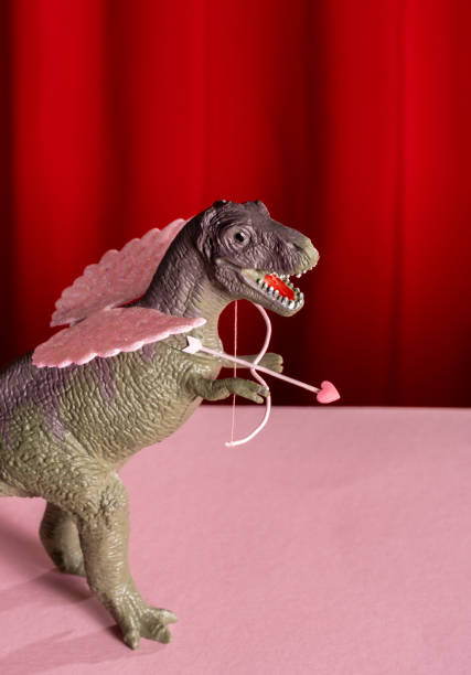 Toy dinosaur with pink wings with bow and arrow