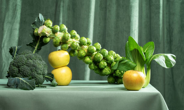 Still life of green vegetables and fruits on a green background