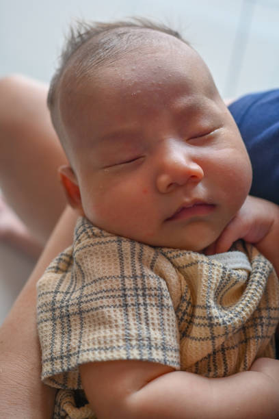 istock The mother is holding her sleeping baby. 2192921597