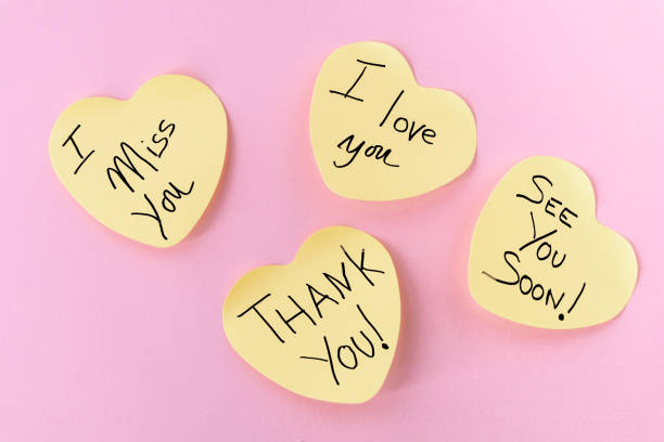 Four Yellow Heart-Shaped Post-It Notes with Loving Messages