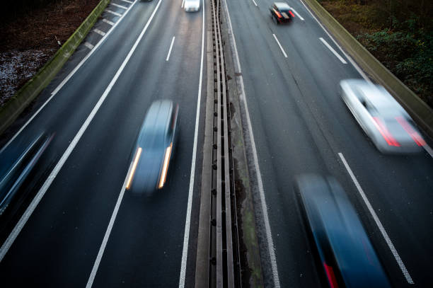 Long exposure of cars on a highway with four lanes.