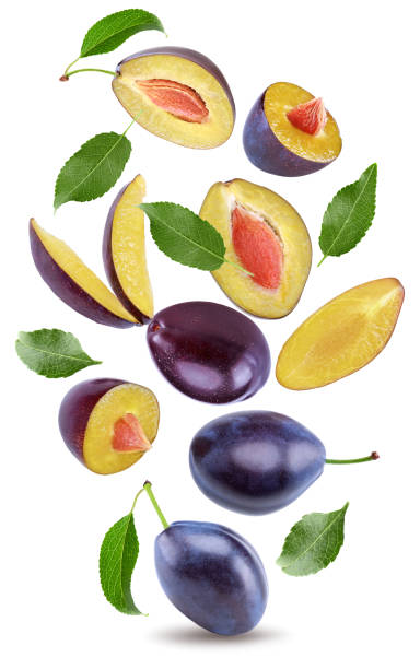 istock flying fresh plum fruit with green leaf and cut plum slices isolated on white background. clipping path 2192923263