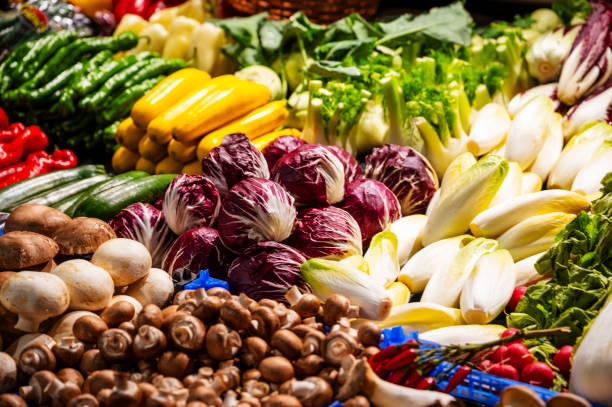 Vegetables are for sale in a display at a market stall.