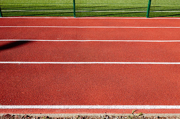 istock Red treadmill on sport field. Running track on the stadium 2192925307