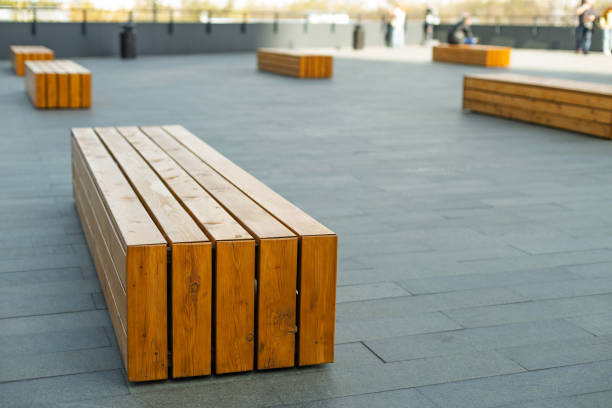 istock A row of wooden benches sit on a grey concrete surface 2192925460