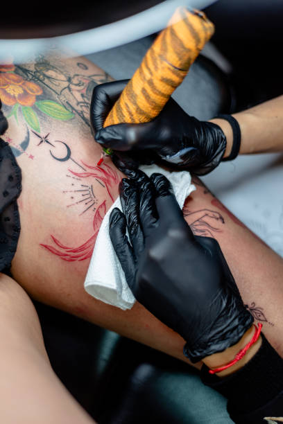 istock Tattoo artist working on creating intricate body art design on client 2192926761