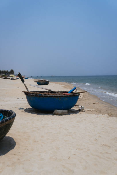 istock Vietnam. Blue Boats Resting on Sandy Beach 2192931362