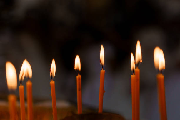 Glowing Candles Illuminating the Darkness in a Serene Setting.