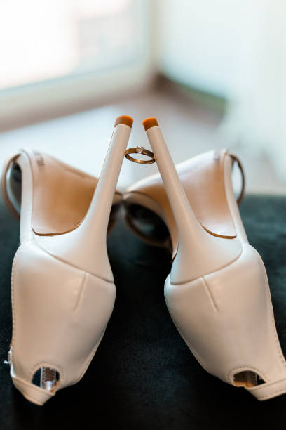 Elegant White Heels with Wedding Ring Displayed in Soft Natural Light
