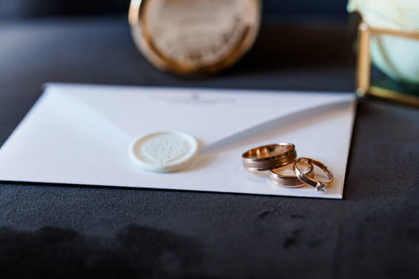 istock Elegantly Arranged Wedding Rings and Sealed Invitation on Velvet Background 2192932744
