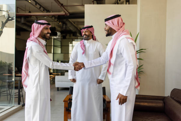 istock Arab business professionals shaking hands in office lobby 2192933502