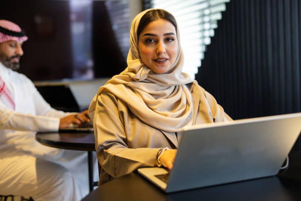 istock Saudi entrepreneur in hijab using laptop at coffee shop 2192933507
