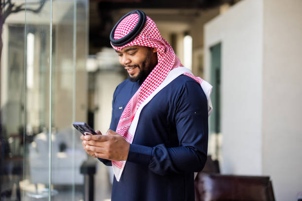 istock Young Saudi businessman using mobile phone in office lobby 2192933844