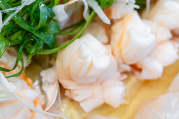 White plates with seafood salad ready to be served, close-up.