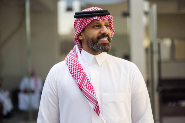 istock Bearded Arab busiessman in traditional attire smiling outside 2192935219