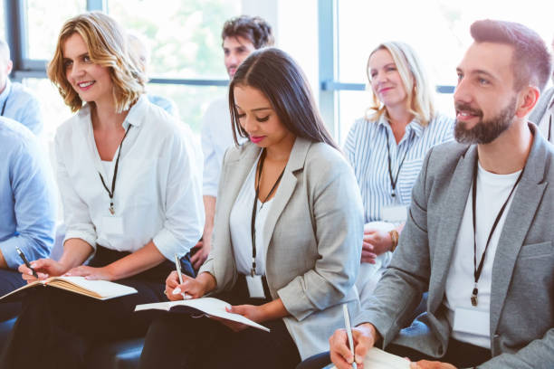 istock People writing in notepads during business conference 2192936344