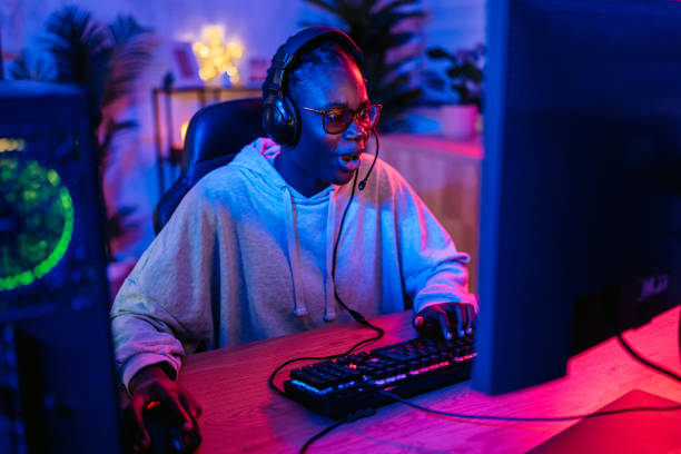 istock Young Black Woman Playing A Video Game On Her Desktop PC 2192936765