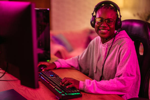 istock Young Black Woman Playing A Video Game On Her Desktop PC 2192937410
