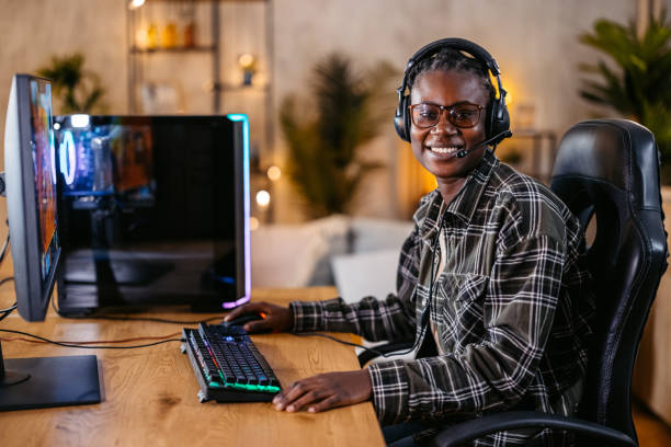 istock Young Black Woman Playing A Video Game On Her Desktop PC 2192938238