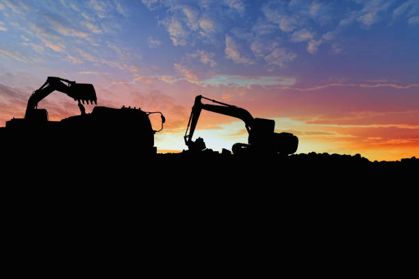 istock Crawler excavators silhouette are digging the soil in the construction site. 2192940697