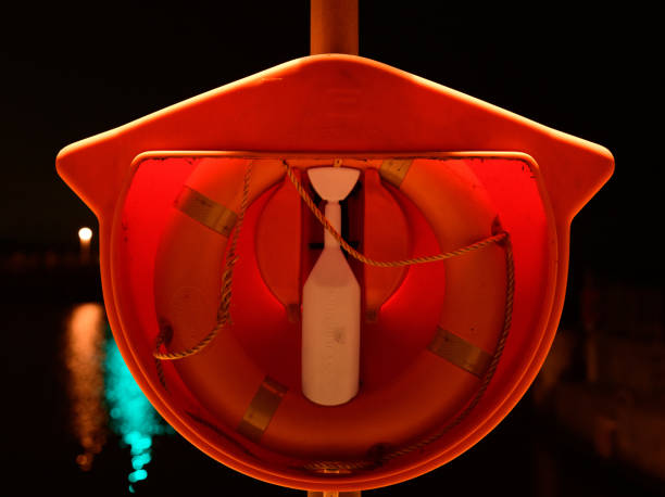 Lifebouy at Liverpool docks at night with fairy lights. Life saving equipment.