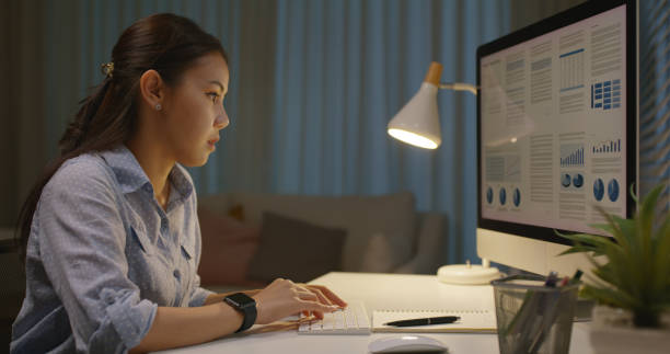 istock Asia people young woman study hard overnight brownout bored remote learn online read data tired sitting head in hands at home office desk workplace think worry in job tough stress workforce issue. 2192948223