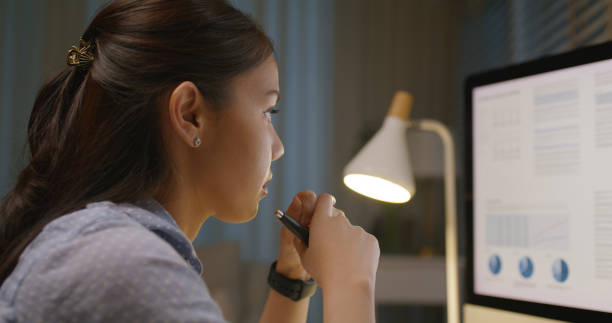 istock Asia people young woman study hard overnight brownout bored remote learn online read data tired sitting head in hands at home office desk workplace think worry in job tough stress workforce issue. 2192948269
