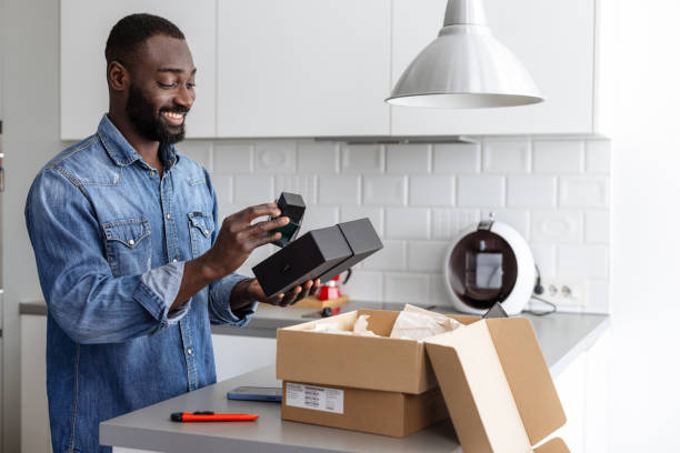 istock Cheerful man unboxing a new fragrance he bought online 2192948514