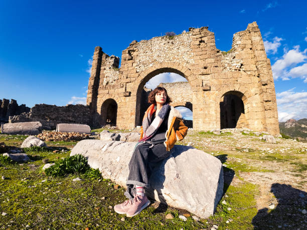 A young traveler in front of the basilica in Aspendos
