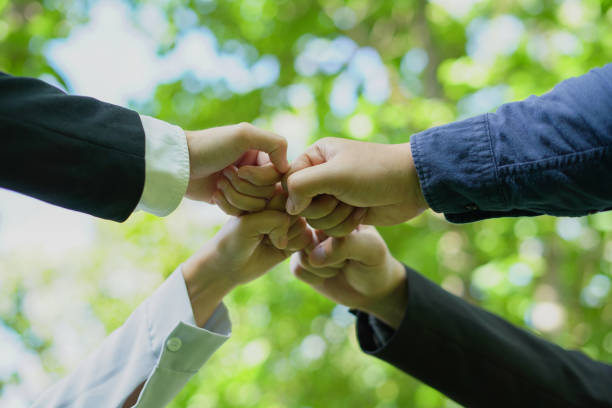 Teamwork and cooperation, businesses join to help nature thrive, embracing green initiatives for sustainable future.